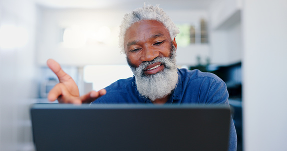 Senior, black man and video call on laptop in home for voip communication, social networking and chat. Elderly guy speaking on computer for virtual conversation, online contact and digital connection