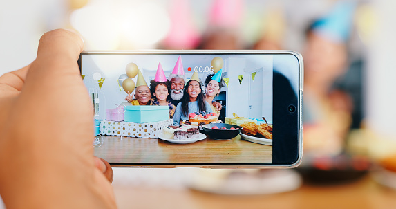 Happy birthday, phone and camera for family photo, celebration or memory together at home. Excited people smile on mobile smartphone display for photography, capture or picture for bonding at event