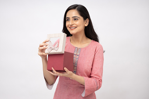 Portrait of Indian young woman wearing casual kurta on white background