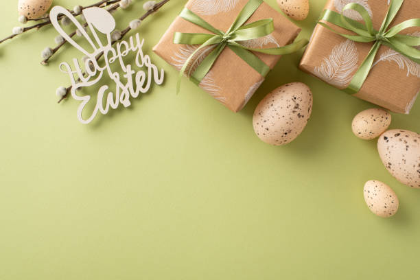 istock Homely Easter composition suggestion. Top-view photo of rustic wrapping gifts, Happy Easter text, quail eggs, natural willow sprigs, on a sage green canvas with blank space for messages or ads 2045456626