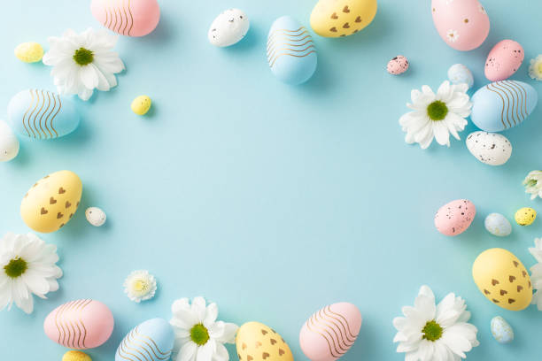 istock Easter inspiration setup: top view photo featuring dyed eggs, and young chamomile on a serene blue background, with a spot for text or ads 2045457164