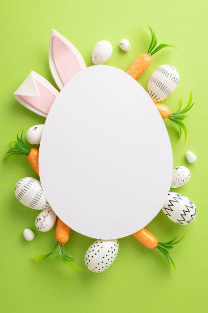 Easter ambiance creation. Top view vertical snapshot of colored eggs, crunchy carrots on a pastel green canvas with charming hare ears peeking from an empty oval for custom messages or marketing creación de ambiente de pascua. vista superior instantánea vertical de huevos de colores, zanahorias crujientes en un lienzo verde pastel con encantadoras orejas de liebre que se asoman desde un óvalo vacío para mensajes personalizados o marketing