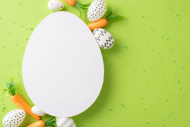 istock Easter delight depicted: top view of colored eggs, bunny-approved snacks, and sprinkles on a light green surface, with an egg-centric card for personalized messages or marketing 2045457184