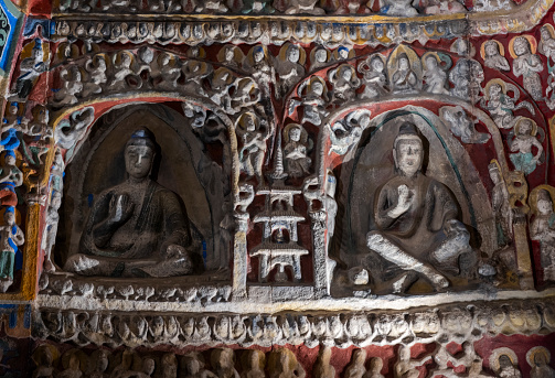 Beautiful stone wall carvings done in the exterior wall of the ancient temple in Tamilnadu.