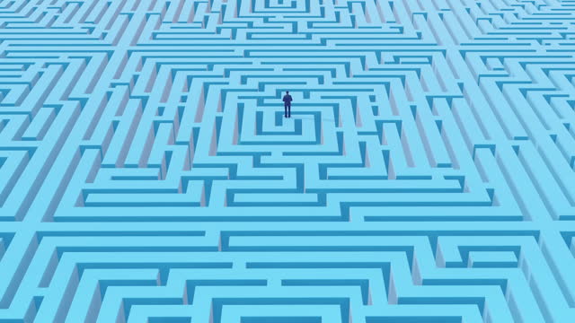 Businessman standing at the beginning of a maze
