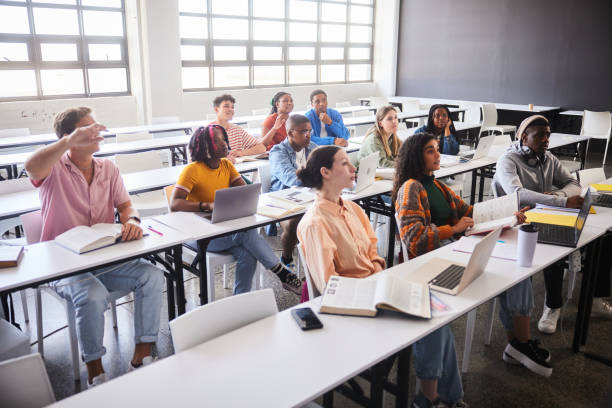 istock Diverse young college students sitting at tables during a class together 2045526605