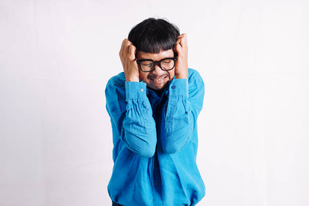 istock Young man suffering migraine pain while working 2045527707