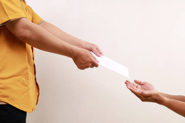istock Young asian muslim man giving a gift on envelope to another man. Ramadan concept 2045546915