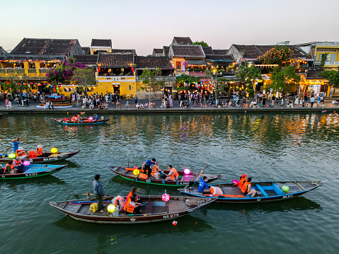 The lantern boats floating on the Thu Bun River at dusk time, Hoi An, Vietnam
