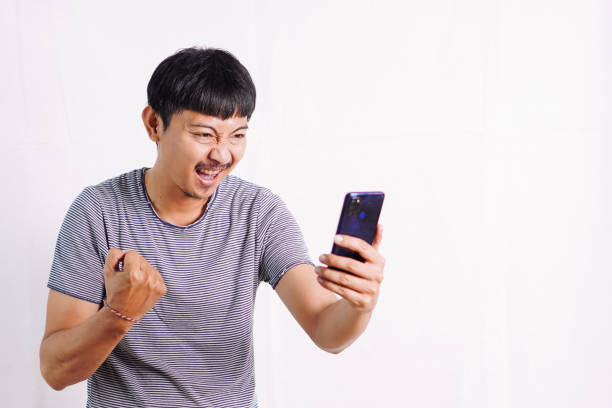 istock Young man very happy and excited doing winner gesture with arms raised, smiling and screaming for success 2045562191