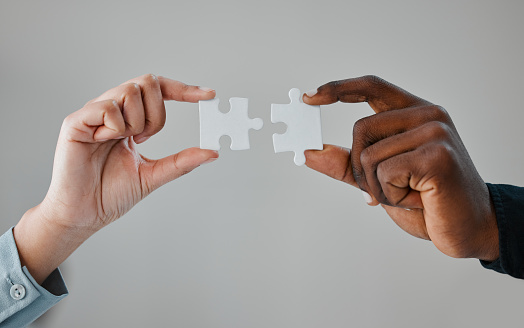 People, hands and puzzle piece for teamwork for business collaboration for startup company, grey background or mockup space. Partnership, fingers and jigsaw for planning project, solution or studio