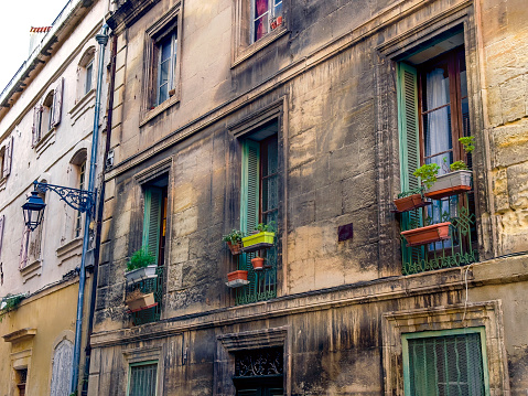 Architectural exterior details from narrow street of ancient city Arles in France