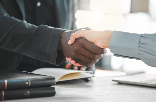 Business people, handshake and lawyers for introduction, agreement and greeting or recruitment. Partnership, closeup and integration or support in court case, network and thank you for hiring on desk