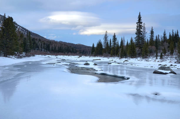 istock Icy river in a winter wonderland under a cloudy sky 2045580413