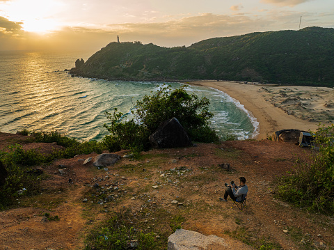 Drone view photographer controling drone for taking photo of Mui Dien headland - the Easternmost of Vietnam - Phu Yen province, central Vietnam