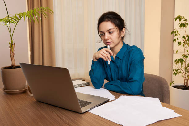 istock pretty calm woman using laptop at home 2045594701
