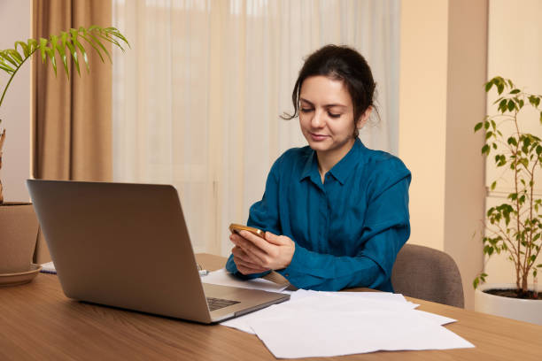 istock businesswoman working on laptop and using phone at home 2045594711