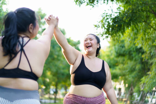 istock Oversize woman exercise at park. 2045615335