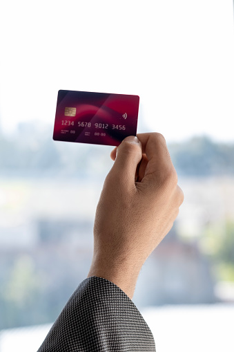 young male hand holding and showing credit card