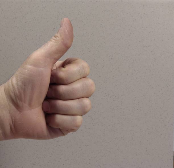 istock Hand clenched into a fist with thumb up. 2045619585