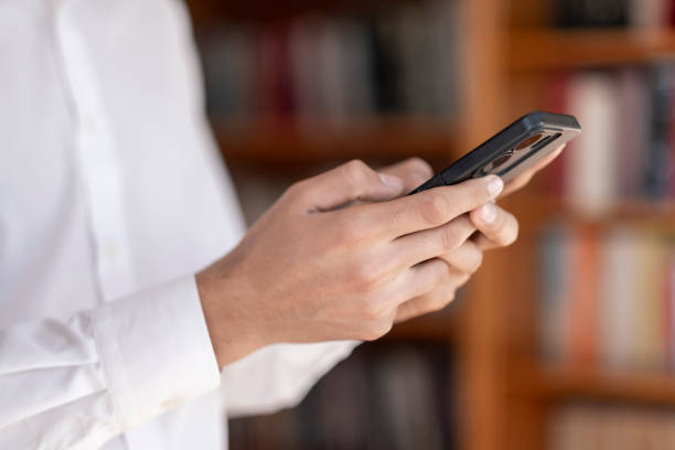 istock Close up shot unknown young male hands holding smartphone 2045621722