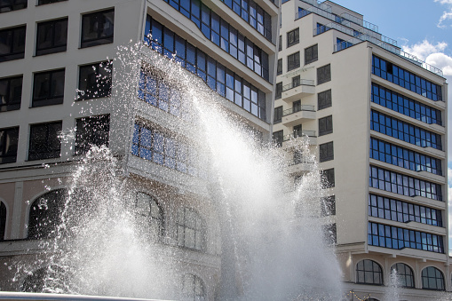 High jets of water fountain in the city close up