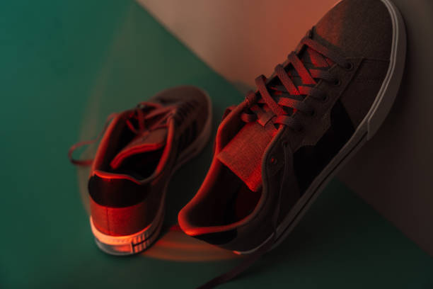 istock Fabric sneakers with rubber white sole under red light 2045651954