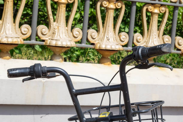 istock Bicycle handlebars in the background of the park 2045655827