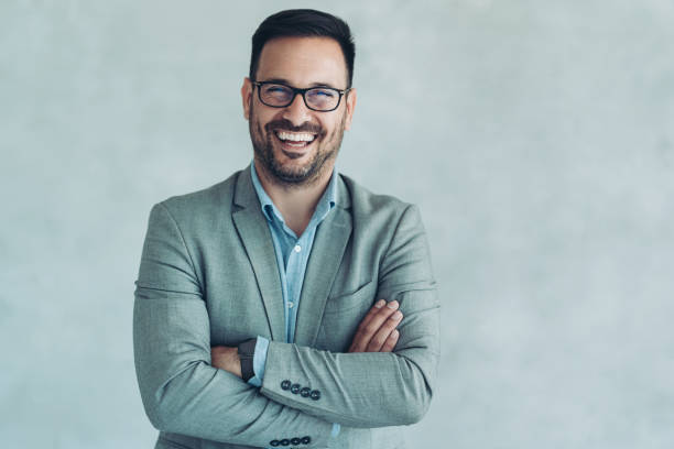 istock Cheerful businessman standing against a wall 2045665441