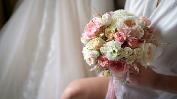 istock Bride with bouquet, closeup. Bride holding bridal bouquet. 2045667536
