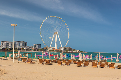 Beach in Dubai with a view of the Ferris wheel