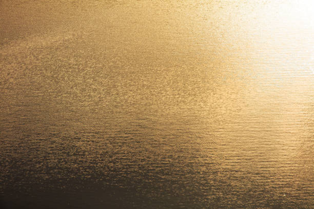 istock Water ripples in golden tones. Abstract background and texture for design 2045736048