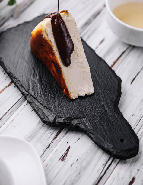 istock Pouring chocolate on delicious San Sebastian cheesecake 2045737132