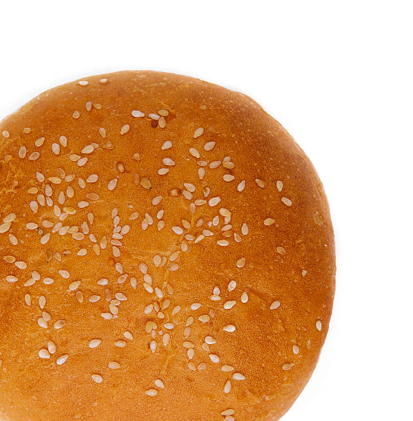 istock Fresh burger bun with sesame seeds isolated on top view 2045742596