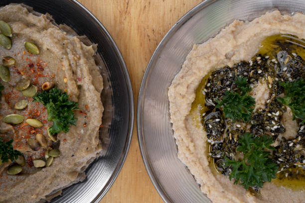 top view of hummus and baba ganoush dishes - eggplant dip baba ghanoush middle eastern cuisine imagens e fotografias de stock