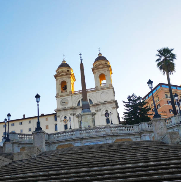 The Spanish Steps are a famous staircase in Rome, connecting the Piazza di Spagna at the base with the Piazza Trinità dei Monti at the top. \n\nThe Trinità dei Monti Church is located at the top of the Spanish Steps. Its full name is the Church of the Most Holy Trinity on the Mount.