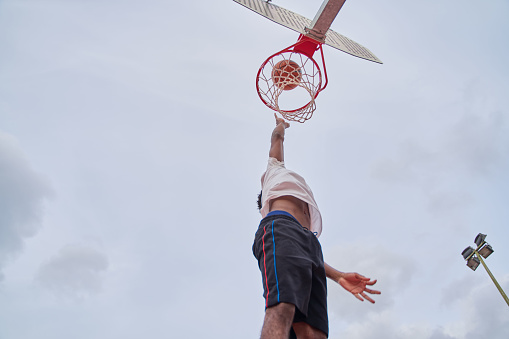 basketball player making slam dunk