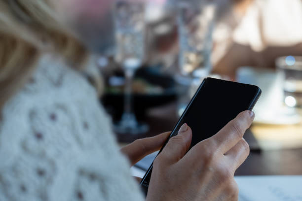 istock The celebration, women's hands with the phone 2045785917
