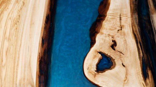 istock Rustic wooden background with brown bark and blue epoxy resin 2045786465