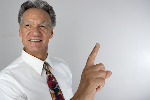 Senior Business Man CEO holding up one finger showing success and job well done