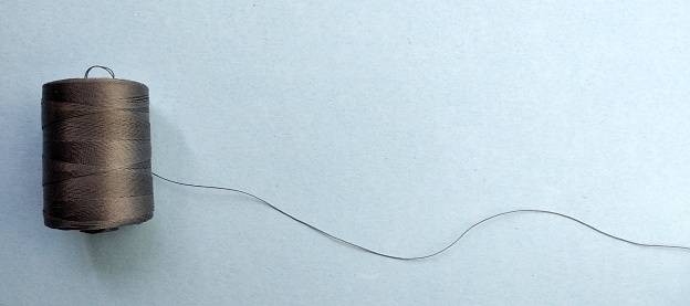 spool of thread on a white background, closeup of photo