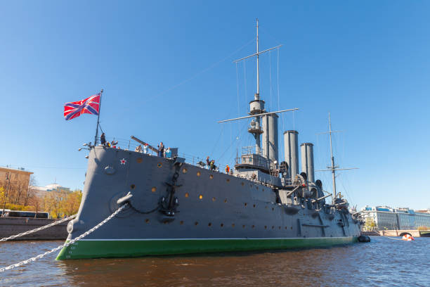 St-Petersburg, Russia - May 21, 2022: Aurora close up view, it is a Russian protected cruiser, currently preserved as a museum ship is moored in Saint Petersburg, Russia. Visitors are on the deck