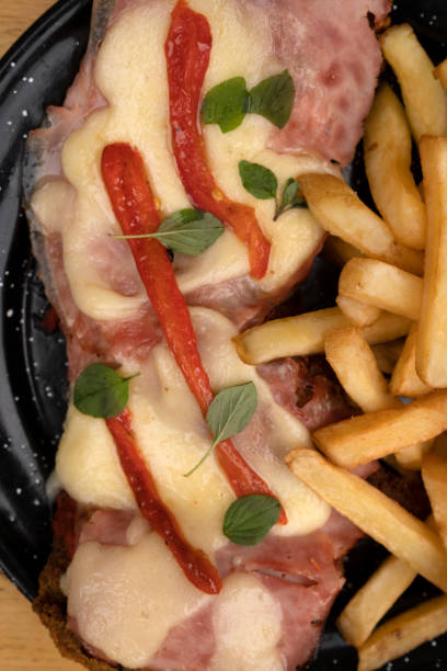 istock Top view of a milanesa with ham, cheese and roasted bell pepper 2045811418