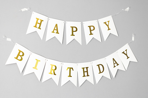 Card template with white Happy Birthday banner flags isolated on grey background