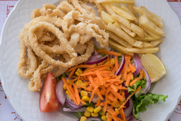 Fried squid with salad and French fries