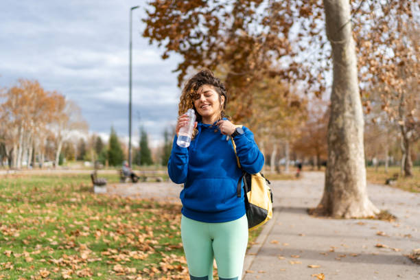 istock Young fit woman taking a break from jogging in the park 2045831288