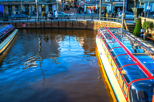 Embark on a picturesque journey through Amsterdam's canals aboard a cruise ship, exploring the historic and iconic cityscape from the water.