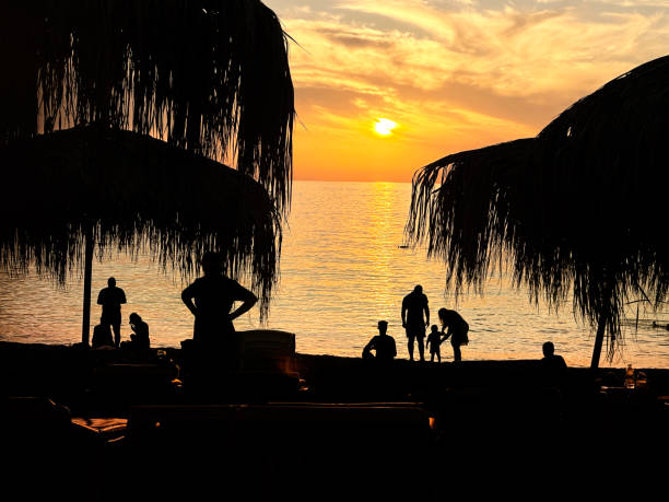 istock People enjoy tropical beach holiday during sunset 2045853960