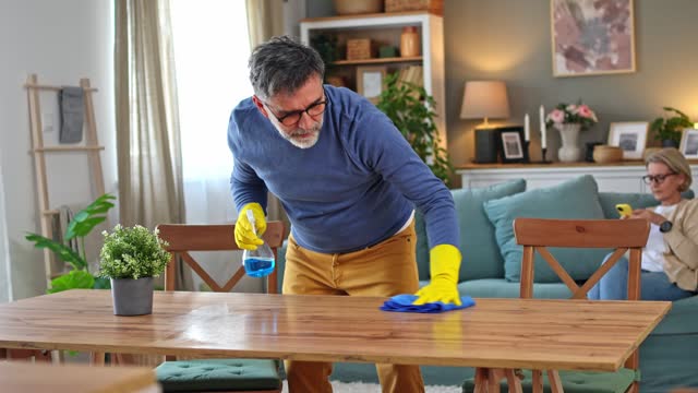 Mature man cleaning his home