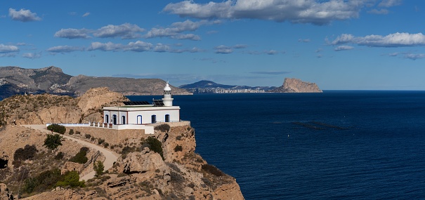 A view of the Albir Lighthouse on the rocky promontory in the Serra Gelada Natural Park between Benidorm and Altea